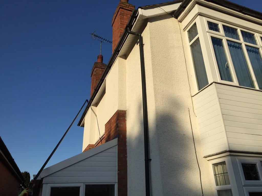 Cleaned white fascias, gutters and windows on a rendered house